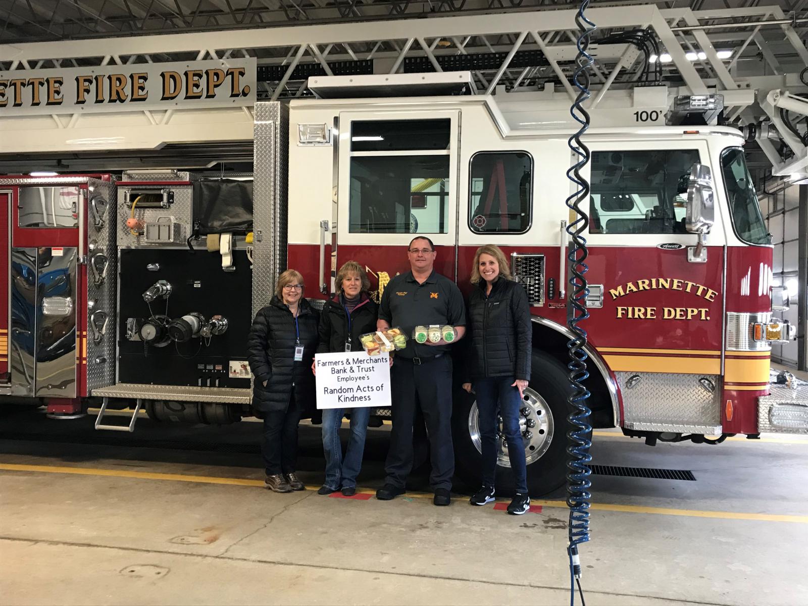 Employees delivering treats to the Marinette Fire Department
