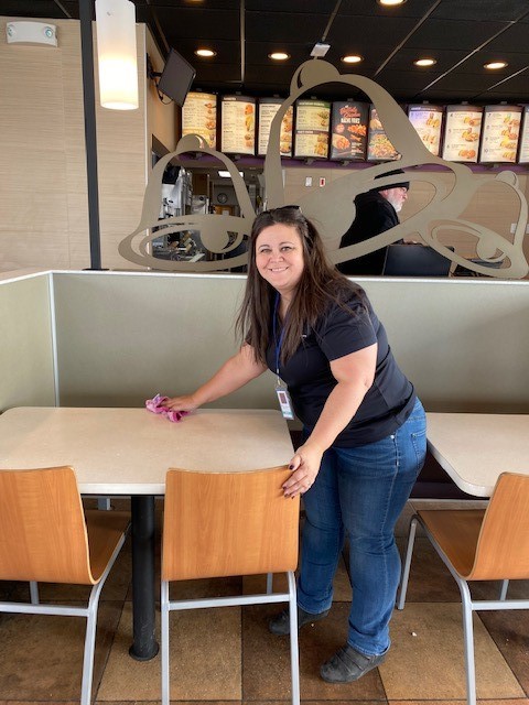 Employee cleaning table at Taco Bell