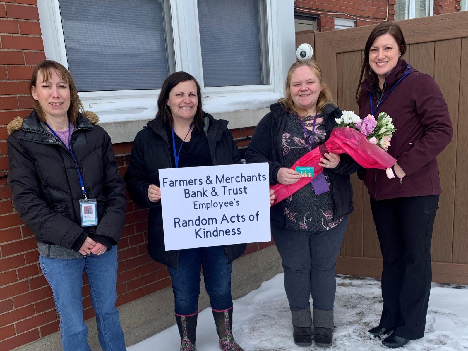 FMBT Employees delivering flowers to the Rainbow House